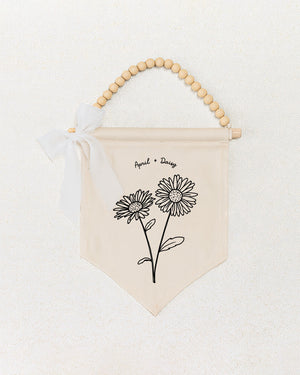 a beige banner with a floral design and a ribbon bow.