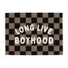 Checkered blanket with 'LONG LIVE BOYHOOD' text in white on a black and brown pattern.