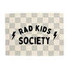 Checkered blanket with 'RAD KIDS SOCIETY' text and lightning bolt symbols on a white background