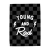 Checkered blanket with 'Young and Rad' text and lightning bolts on a white background